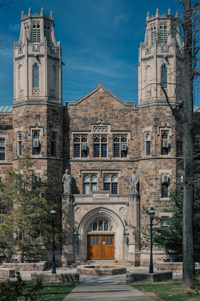 Majestic Gothic Revival building at a university campus with towers and detailed facade.